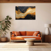 A canvas print featuring an abstract black and gold design, displayed above an orange sofa in a room with a minimalist decor.