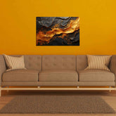 A canvas print featuring an abstract black and gold design, displayed above a brown sofa with striped cushions, placed in a room with a yellow wall.