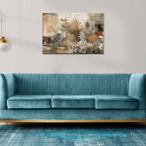 A canvas print featuring a floral design with the word 'Love' displayed, mounted on a wall above a blue couch with gold accents.