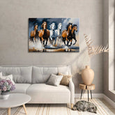 A canvas print featuring a dynamic painting of horses in motion, displayed above a modern sofa in a well-lit living room setting.