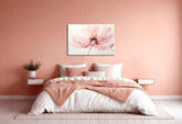A canvas painting of a pink flower displayed above a bed in a room with pink walls.