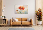 A canvas print of an orange lily flower displayed above a brown sofa in a room with decorative items and a large window.