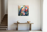A canvas print featuring a colorful painting of birds on a branch, displayed above a table in a room with a staircase.