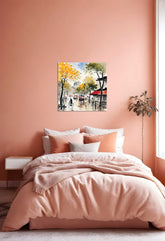 A framed canvas painting featuring an outdoor village scene with trees, buildings, and people, displayed on a bedroom wall.