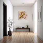 A framed canvas print featuring a floral pattern, displayed on a white wall above a wooden bench in a room with parquet flooring and minimalist decor.