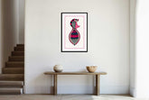A framed canvas print depicting an abstract fish design hanging on a wall over a table in a room with stairs to the left.