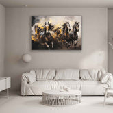 A canvas print featuring a painting of multiple horses in motion, displayed above a white sofa in a minimalist interior setting.