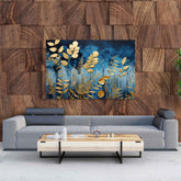 A canvas print featuring a blue background with gold decorative flowers, displayed above a grey sofa on a wooden wall.