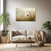A canvas painting depicting a flower in a grassy field, displayed above a beige sofa in a room with a minimalist decor.