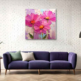 A canvas print featuring a vibrant abstract floral pattern, displayed on a wall above a purple couch with a brick wall background.