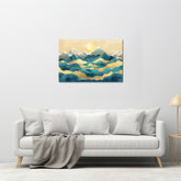 A canvas print featuring a mountainous landscape with a golden line in the sky, displayed on a wall above a white sofa with grey pillows.
