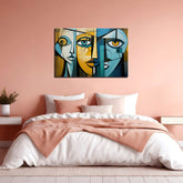 A canvas print featuring an abstract depiction of faces in blue and yellow colors, displayed above a bed in a room with pink walls.