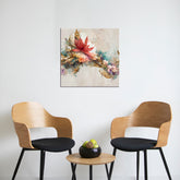A canvas print featuring a floral painting with a mix of vibrant colors displayed on a wall between two wooden chairs and a small round table with a decorative item on top.