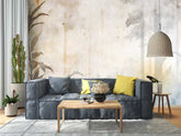 A serene living space with a gray couch, natural wood accents, and a textured wallpaper that adds depth and visual interest to the room.