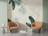 A stunning tropical leaf wallpaper with gold outlines and splatters, creating a sophisticated ambiance in a cozy seating area.