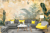 Living room with a gray sectional sofa, yellow chairs, and a tropical wall mural.