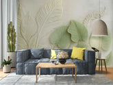 Living room with a blue sofa, yellow pillows, and decorative leaf wall art.