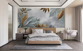 Modern bedroom with a large wall mural of leaves above a bed.
