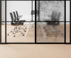 Modern office with glass walls and black chairs