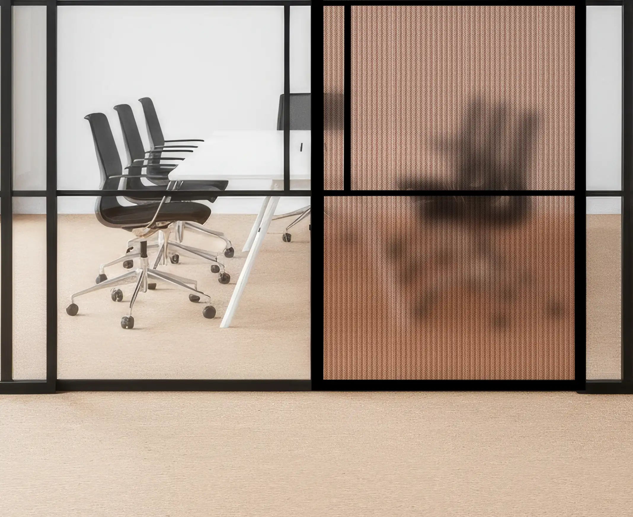 Modern office setting with glass walls, black chairs, and a wooden floor.