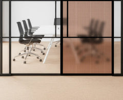 Modern office setting with glass walls, black chairs, and a wooden floor.