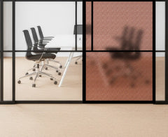 Modern office setting with glass walls, chairs, and a table.