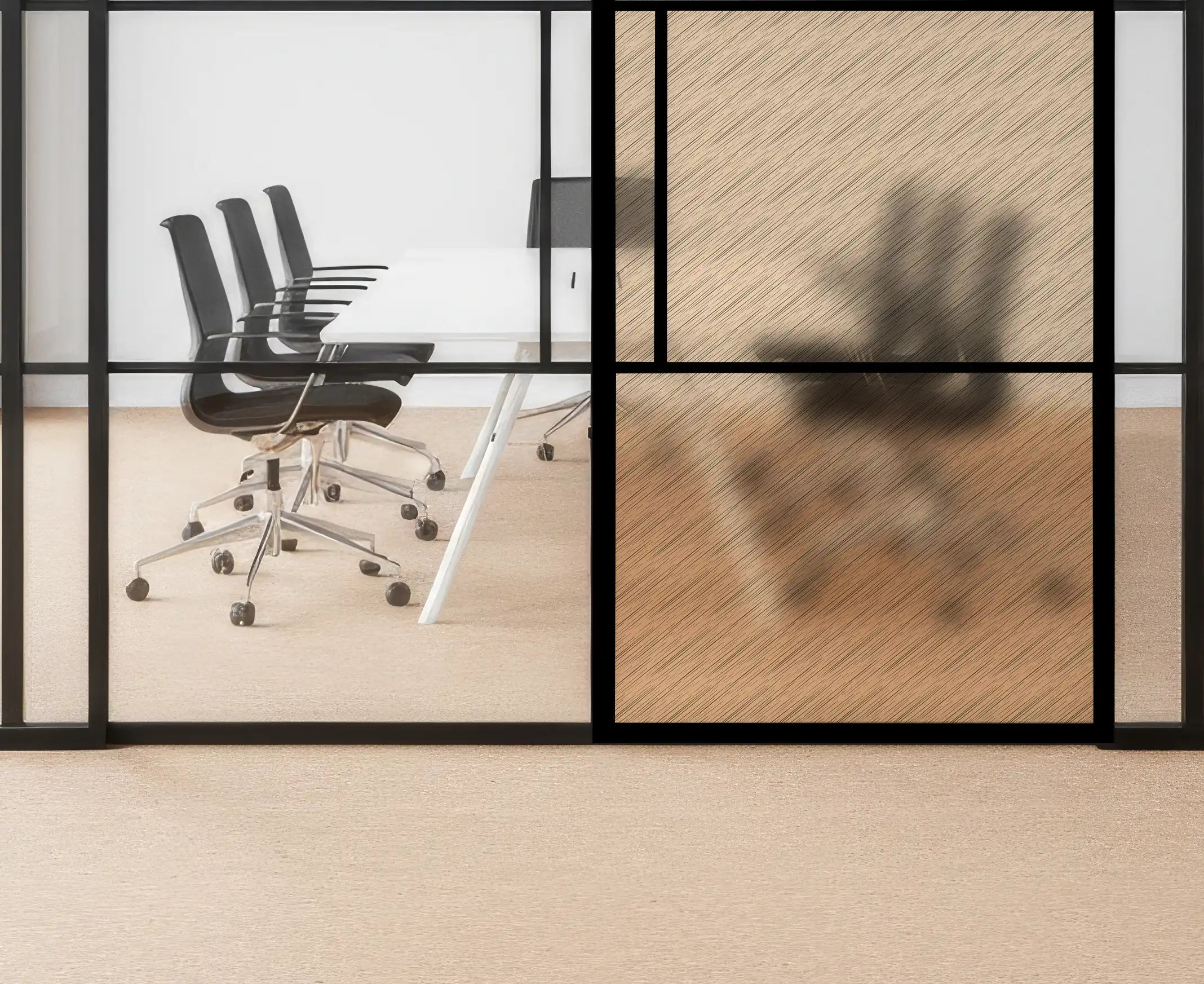 Modern office setting with glass walls, black chairs, and a wooden floor.