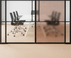 Modern office conference room with glass walls and black chairs.
