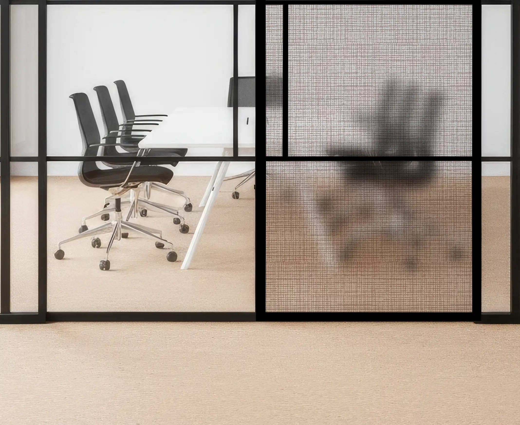 Modern office setup with black chairs and a glass wall.