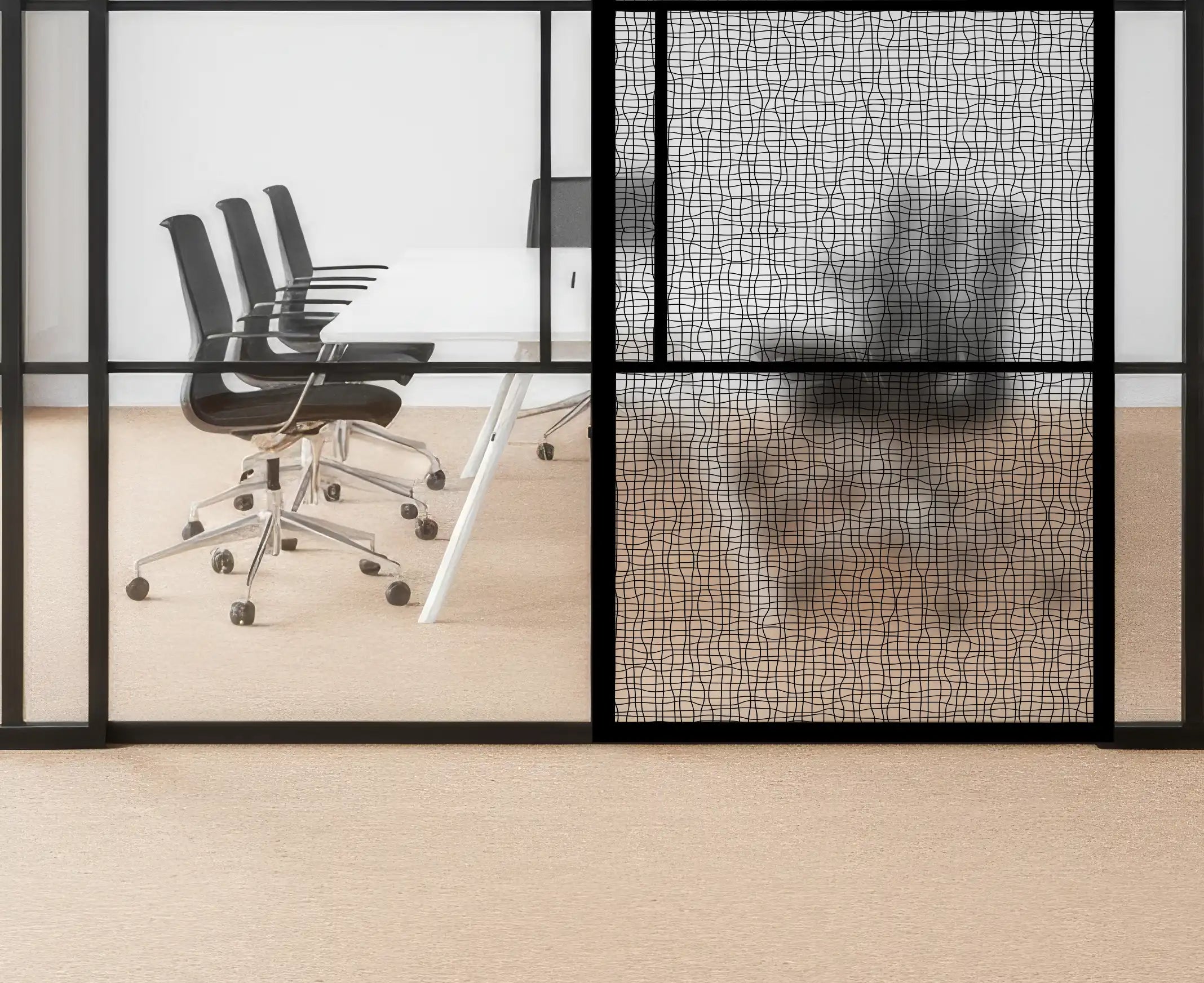 Modern office interior with glass walls, black chairs, and a textured wall.