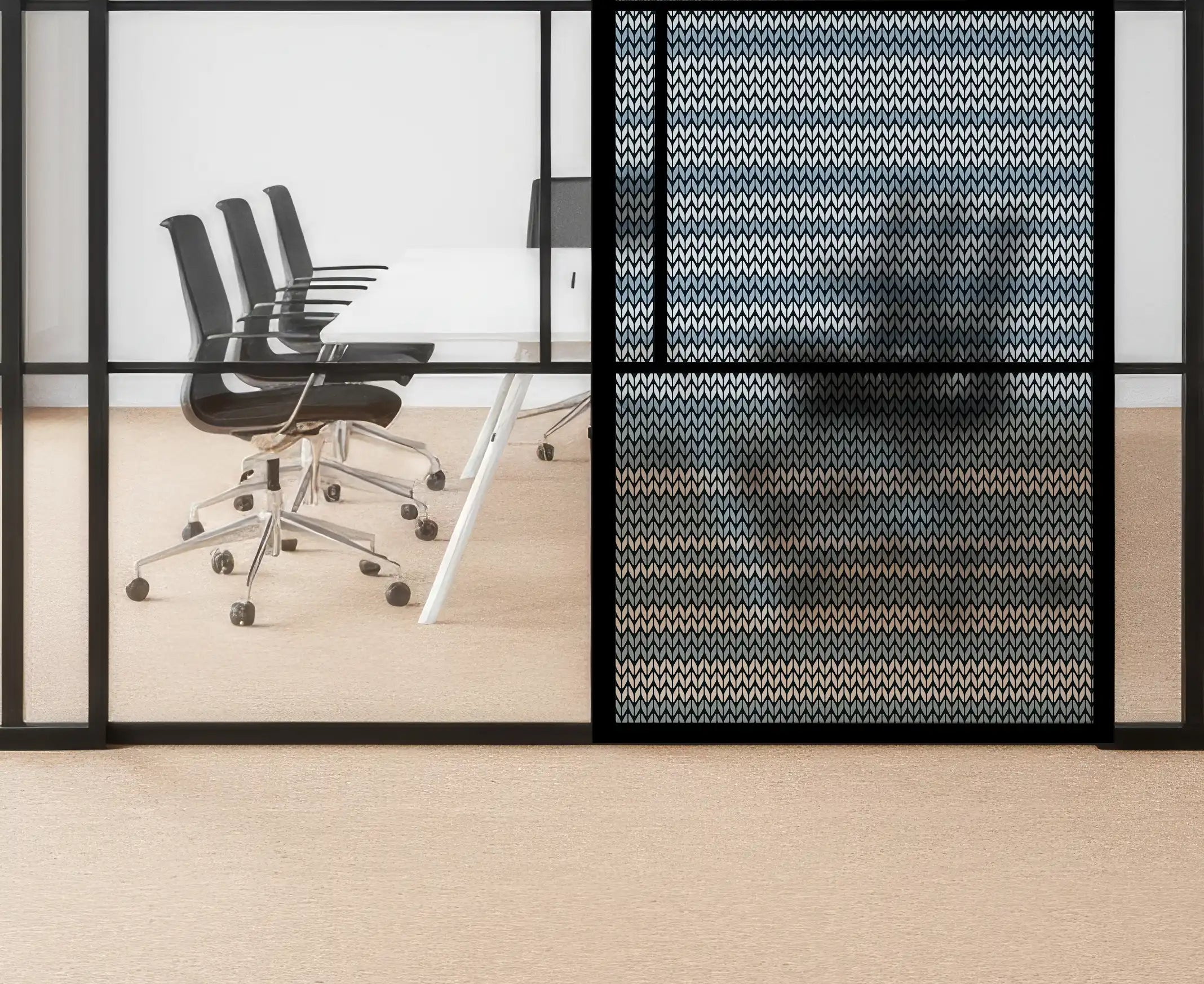 Modern office space with glass walls and black chairs.