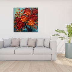 A vibrant canvas print featuring a floral painting with predominantly red and orange flowers, displayed above a gray sofa in a room with a minimalist decor.