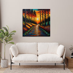 A canvas print featuring a vibrant sunset with a pathway through trees, displayed on a wall above a white sofa in a cozy living room setting.