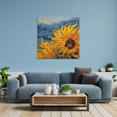 A vibrant painting of a yellow sunflower with a blue sky in the background, displayed on a wall above a gray sofa and wooden coffee table.