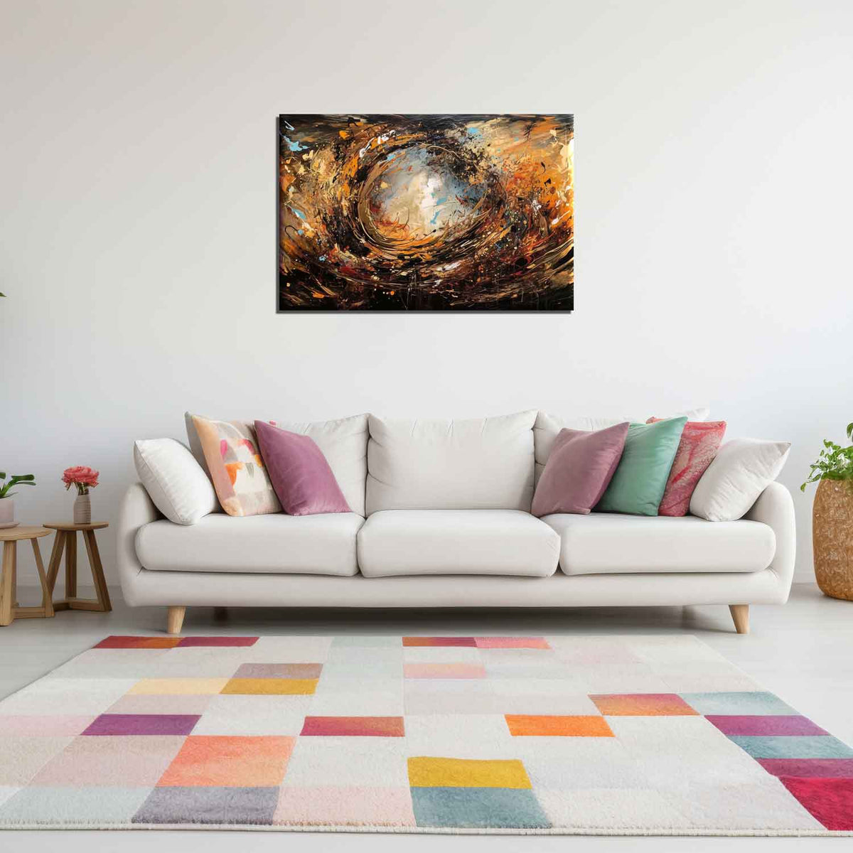 A canvas painting with a abstract design featuring swirls of gold and dark colors, displayed above a white sofa with multiple colored cushions on a colorful rug.
