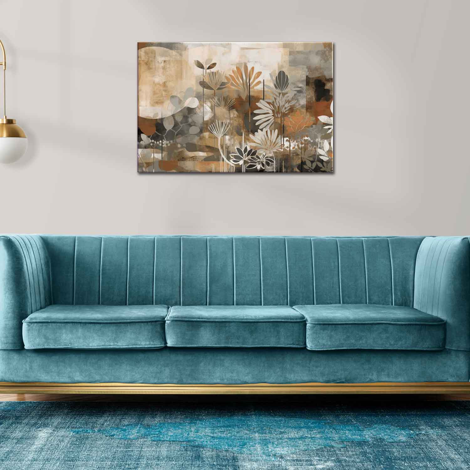 A canvas print featuring a floral design with the word 'Love' displayed, mounted on a wall above a blue couch with gold accents.