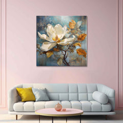 A canvas painting of a white magnolia flower on a branch, displayed above a white sofa with yellow cushions, against a pink wall.