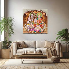 A canvas print depicting Hindu deities displayed above a modern living room setup with a sofa and houseplants.