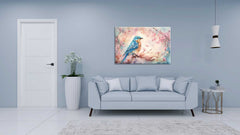 A canvas painting of a bird on a branch with floral elements, displayed above a grey sofa in a room with a light blue wall.