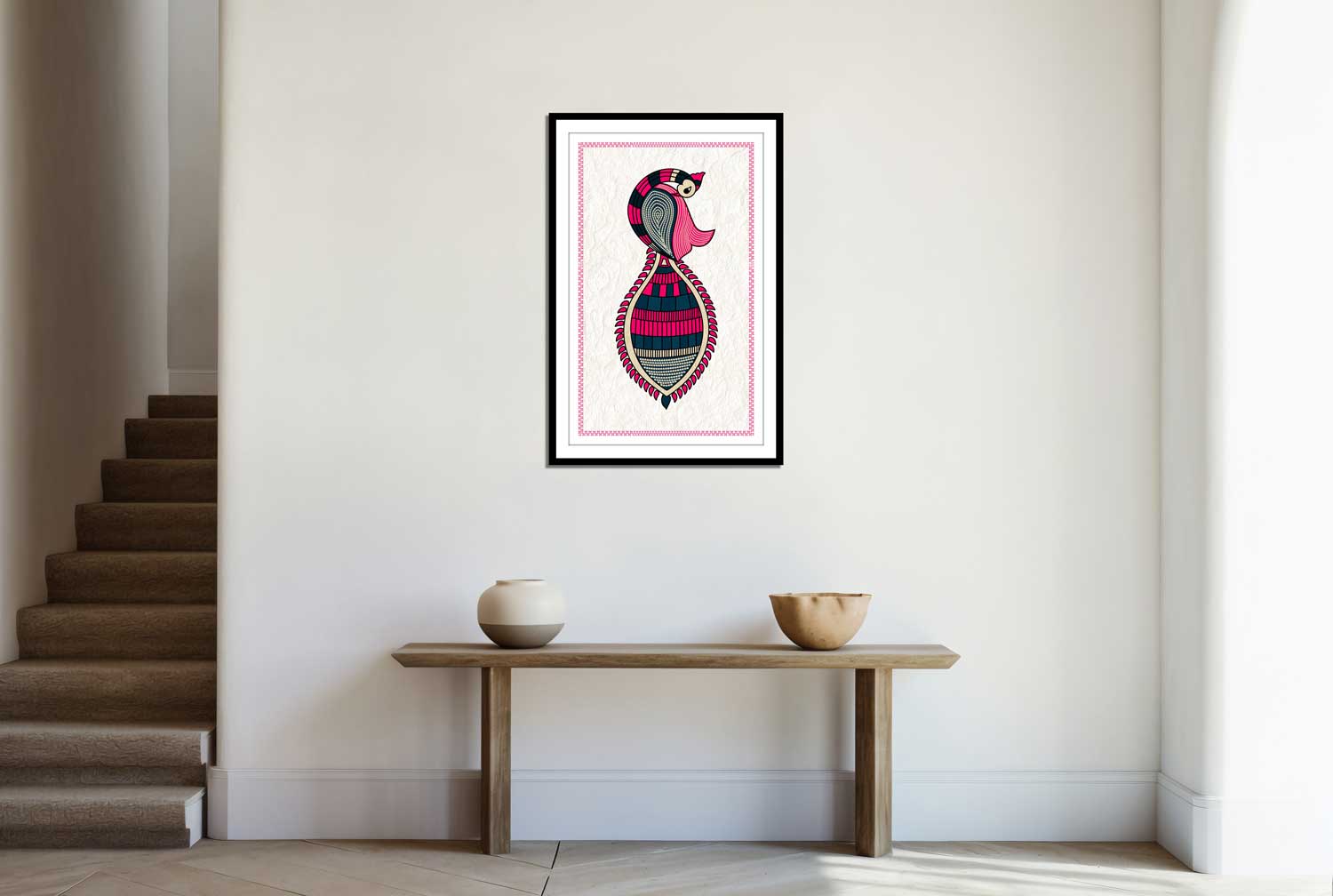 A framed canvas print depicting an abstract fish design hanging on a wall over a table in a room with stairs to the left.