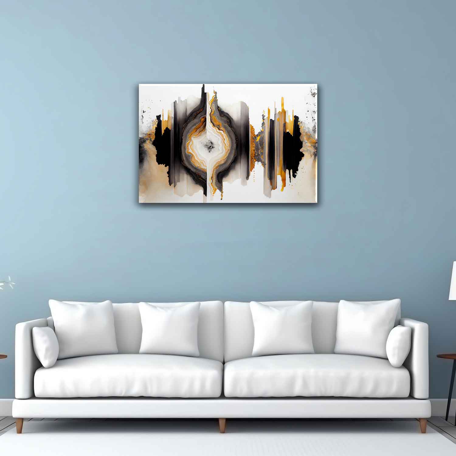 A canvas print featuring an abstract design with black, white, and gold colors, displayed above a white sofa on a blue wall.