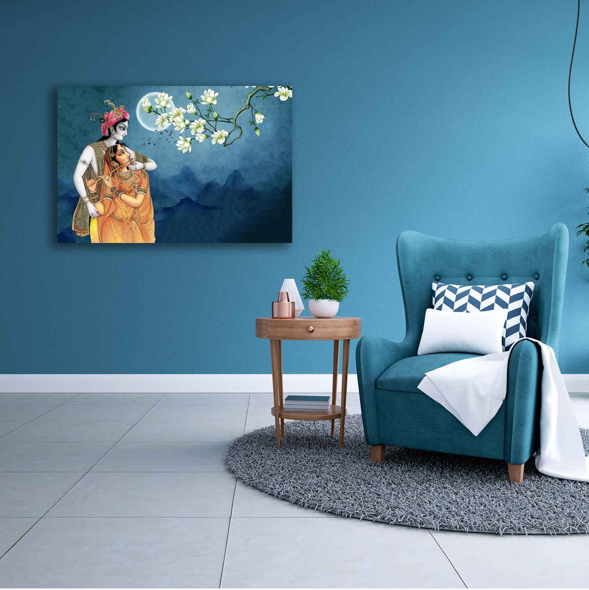 A canvas painting depicting two individuals in traditional attire hanging on a blue wall above a small table with a plant and a book. adjacent to a blue armchair with a white cushion.