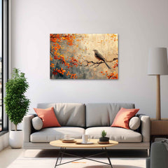 A canvas print depicting a bird perched on branches with orange leaves, displayed above a grey sofa with coral cushions.