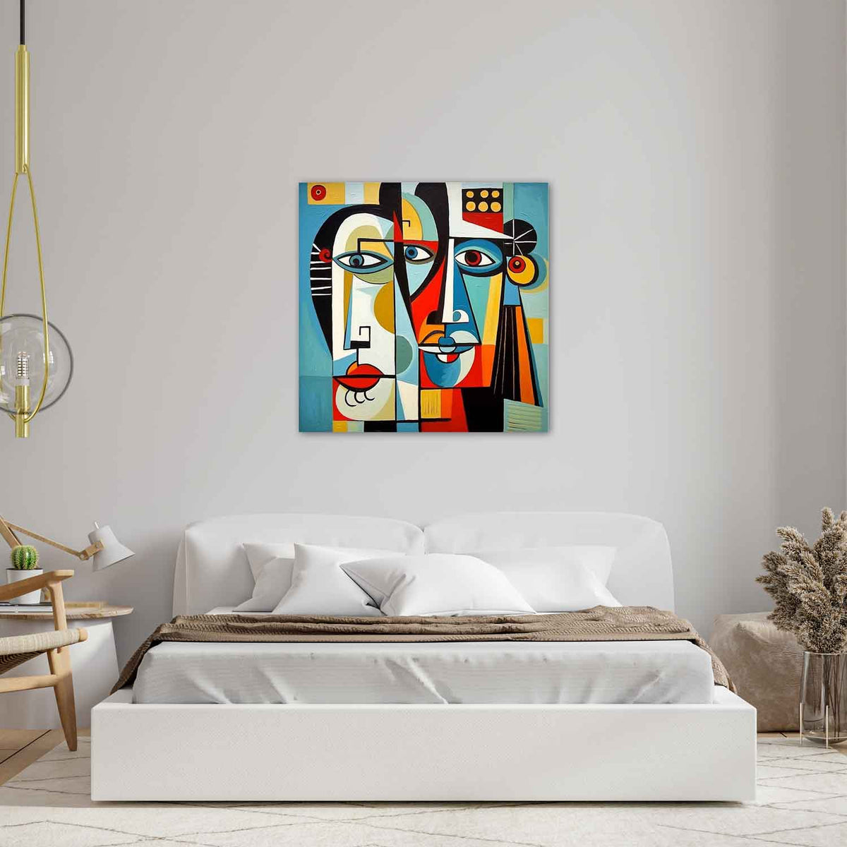 A colorful abstract painting featuring stylized faces with geometric shapes, displayed above a bed in a room with minimalist decor.