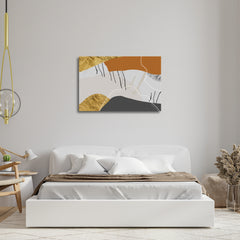 A canvas print featuring geometric shapes in beige, gray, black, and gold colors, displayed above a bed in a room with a minimalist decor.