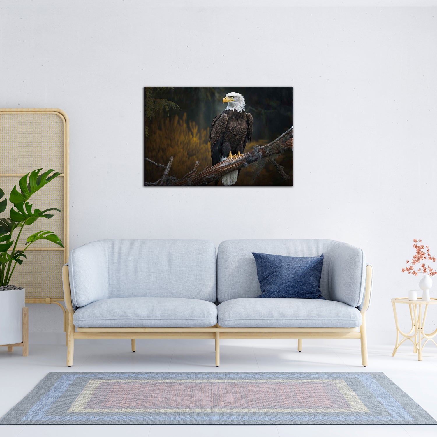 A canvas painting of an eagle perched on a branch, displayed above a grey sofa with a blue cushion, placed in a room with a wooden floor, a potted plant to the side, and a decorative wall piece to the right.