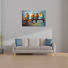 A canvas print featuring three colorful birds sitting on a branch, displayed above a gray sofa with blue cushions in a room with minimal decor.