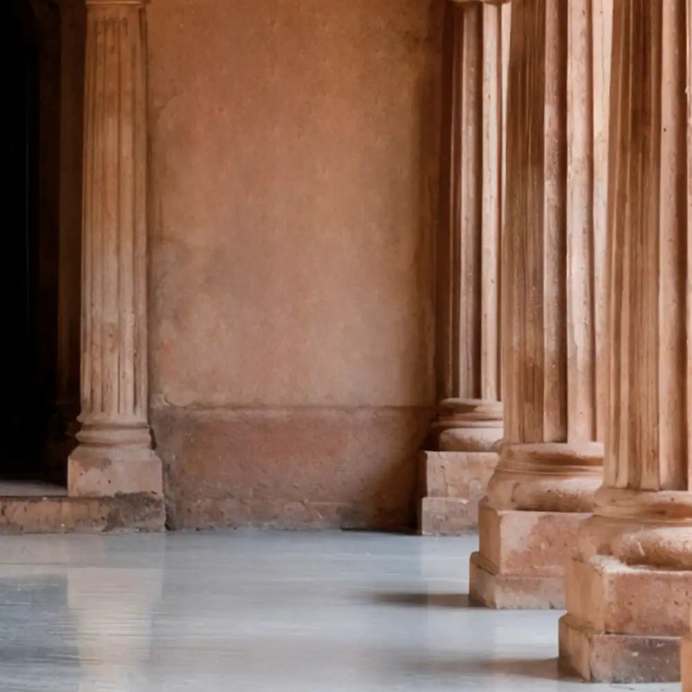 Ancient stone columns in a large, open hall with a high ceiling.