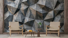 Geometric wall design with two chairs and a small table in a room.