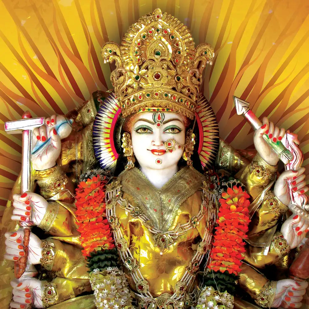 Decorative statue of a deity with intricate gold and red attire against a yellow background